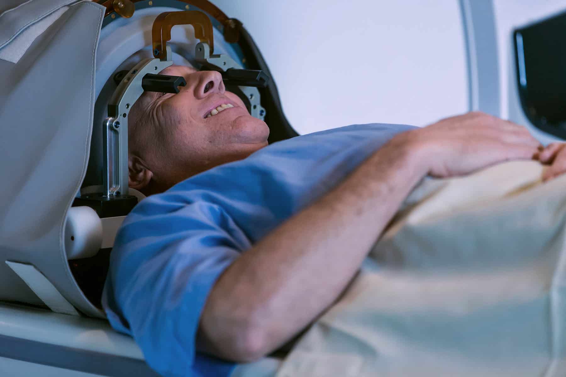 Patient positioned with a head frame for MRI-guided focused ultrasound treatment.